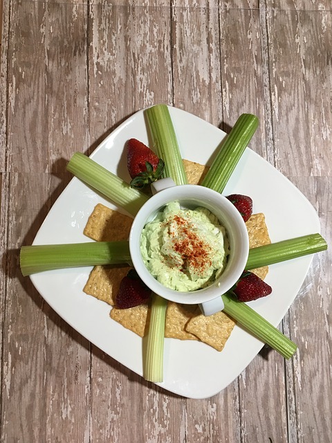 hummus plate with celery sticks and crackers