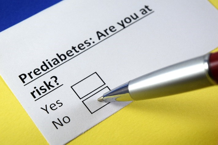 Piece of paper that says Prediabetes are you at risk? and a check box of Yes or No with a pen pointing at NO.